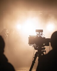 Studio Scene with Professional Film Camera Surrounded by Fog and Bright Lights Creating an Atmospheric Production Environment