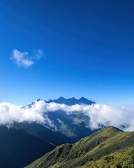 Majestic Mountain Range Under Clear Blue Sky with Fluffy Clouds in Idyllic Landscape