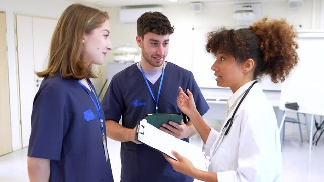Medical team discussing patient information in hospital room