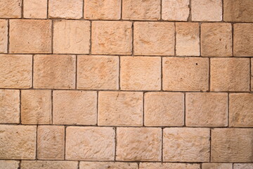 Naklejka premium Brick wall texture. Orange yellow red brick building wall, Iraq, Middle East