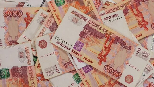 A lot of five-thousand-dollar Russian bills are slowly rotating in a circle, the monetary background. The Russian currency.