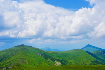green mountain chains in dense mist and clouds
