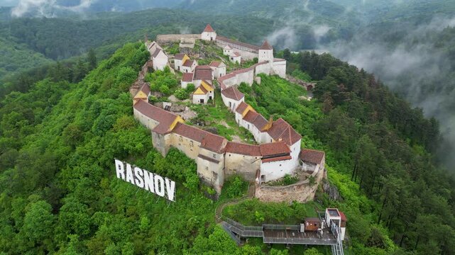 Majestic Rasnov Citadel perched atop a verdant hill, exuding historical grandeur