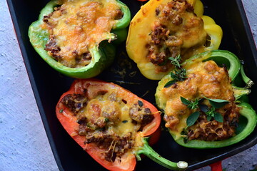 Close-up of vibrant stuffed bell peppers filled with seasoned ground beef, bulgur, and melted...