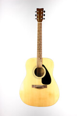 Naklejka premium acoustic guitar made of light wood on a white background. an isolated object. close-up.