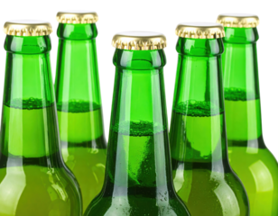 Close-up of five green glass beer bottles with gold caps against a black background.