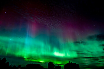 Moon light lake with a dancing northern lights in Farnebofjarden national park in north of Sweden.