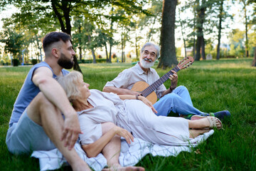 Fototapeta premium Family Enjoying a Relaxing Day Outdoors With Guitar and Nature..