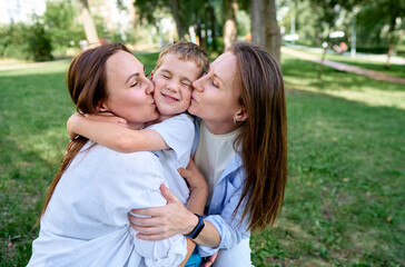 Happy Family Sharing Loving Moments in a Green Outdoor Setting..