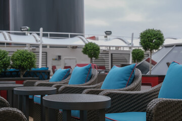 Outdoor whirlpool jacuzzi and private sun deck onboard modern luxury cruiseship cruise ship ocean liner with turquoise water, elegant rattan loungers and deck chairs for suite guests passengers