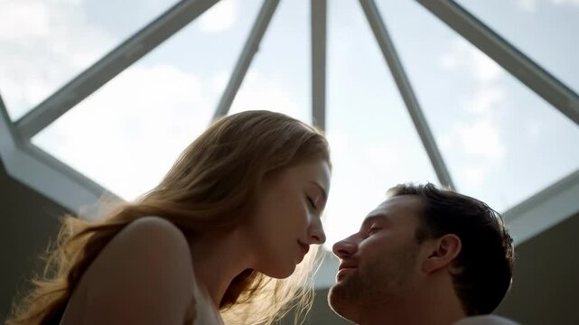 A romantic couple sharing a kiss under a skylight, with soft natural light enhancing the intimate atmosphere and a serene background - hot kissing bed
