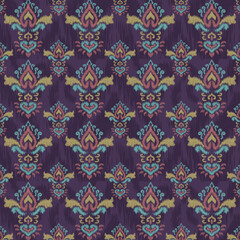 Seamless rich purple damask pattern with an Ikat or blurred weave texture. Ornate baroque motifs featuring teal, pink, and gold accents. Excellent for luxury textile, wallpaper, or bold bohemian fashi