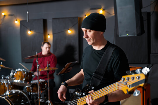 Musicians Rehearsing Together in a Studio Room with Decor Lighting..
