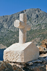 a stone memorial cross in Telendos island, Dodecanese, Greece