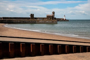The outer harbor and lighthouse in the town of Whitehaven on the coast of Cumbria in the northwest...