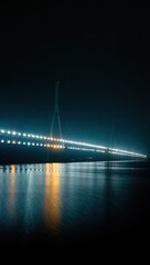 Illuminated bridge at night reflecting on water