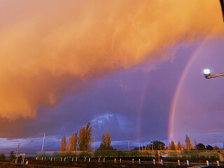 Double rainbow over a storm in the city