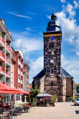 St. Margaret Church in Gotha with city square, cafes and residential buildings on a sunny summer day