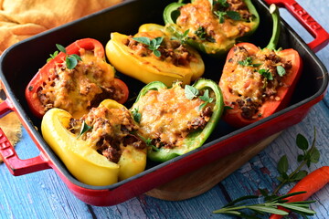 Stuffed peppers with meat, cheese and vegetables in a baking dish