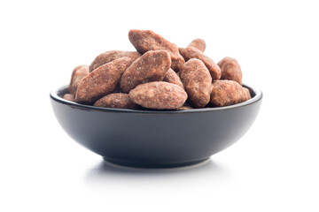 Almond nuts coated in sugar and honey in bowl isolated on white background.