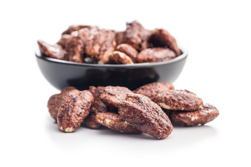 Pecan nuts coated in sugar and honey isolated on white background.