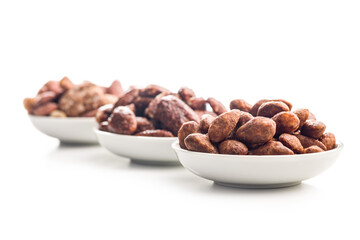 Nuts coated in sugar and honey in bowl isolated on white background.