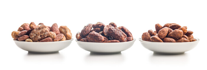 Nuts coated in sugar and honey in bowl isolated on white background.