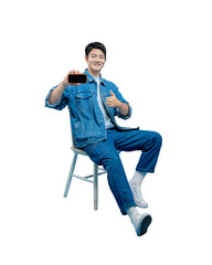 Full body image of young asian man sitting on chair , using phone and posing on PNG background