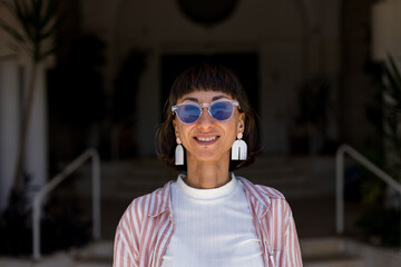 Happy woman portrait and piercing in lower lip, confidence or cheerful attitude in city. Woman,...