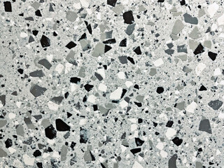 Close-up of a speckled terrazzo surface in shades of gray and white