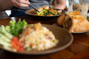 A person is currently seated at a table enjoying a plate of food