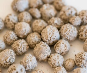 Close-up of multiple beige-colored expanded clay aggregate balls used for hydroponics and construction