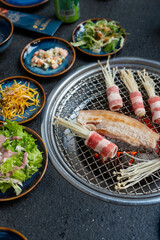 A plate of delicious food sits on a table with several bowls