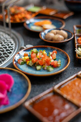 A table arranged with plates of food and various delicious sauces