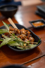 A close up view of a bowl filled with delicious food placed on a table