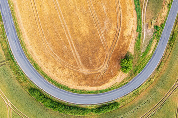 View vertically downwards on a 180-degree curve amidst fields and meadows in the Taunus