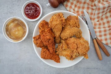 Fried crispy chicken with tomato sauce  and mashed potatoes on a white plate 