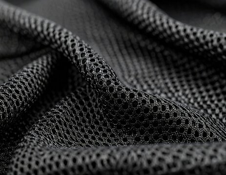 Close-up of black mesh fabric with intricate texture and pattern