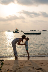 Tender Moment at the Beautiful Beach A Mother and Child Delightfully Embracing Each Other