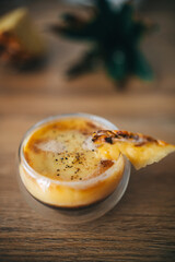 Exotic fresh pineapple puree with espresso coffee drink in double-bottom transparent glass