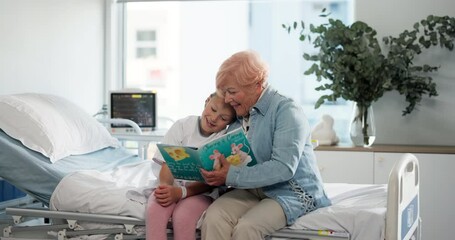Hospital, book and grandmother reading with child for bonding, support or family time together. Happy, care and senior woman with girl kid for enjoying story, novel or literature in clinic room. - Powered by Adobe