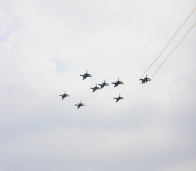 Formation flight of the Royal Thai Air Force T-50 Golden Eagle and F-16 Fighting Falcon at airshow in Thailand.
