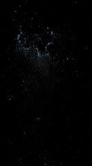 A striking visual of flour explosion against a dark background, creating a dramatic cooking moment.