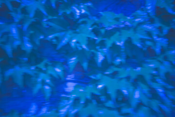Vibrant foliage glows in mysterious blue light under a twilight sky