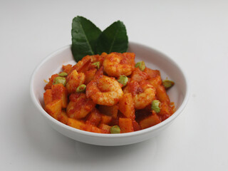 Stir fried shrimp and potato cooked in chilies in white bowl