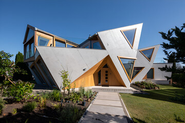 Modern house with triangular windows and concrete pathway