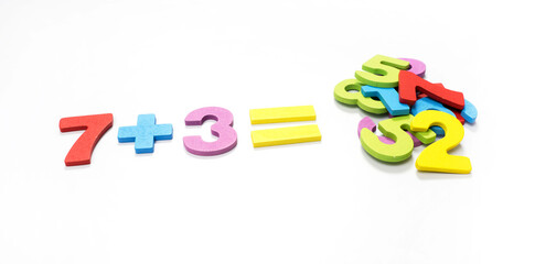 Fototapeta premium Numbers made from cut wood, multi-colored on a white background