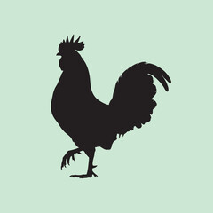 vector silhouette of a rooster on a green background