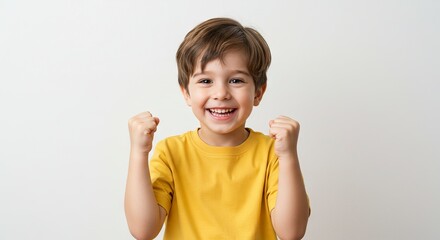 Excited Little Boy Cheering with Fists Raised in Celebration Indoors