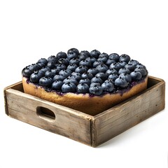 A blueberry cake sits in a rustic wooden box with a handle against a plain white background in a studio shot